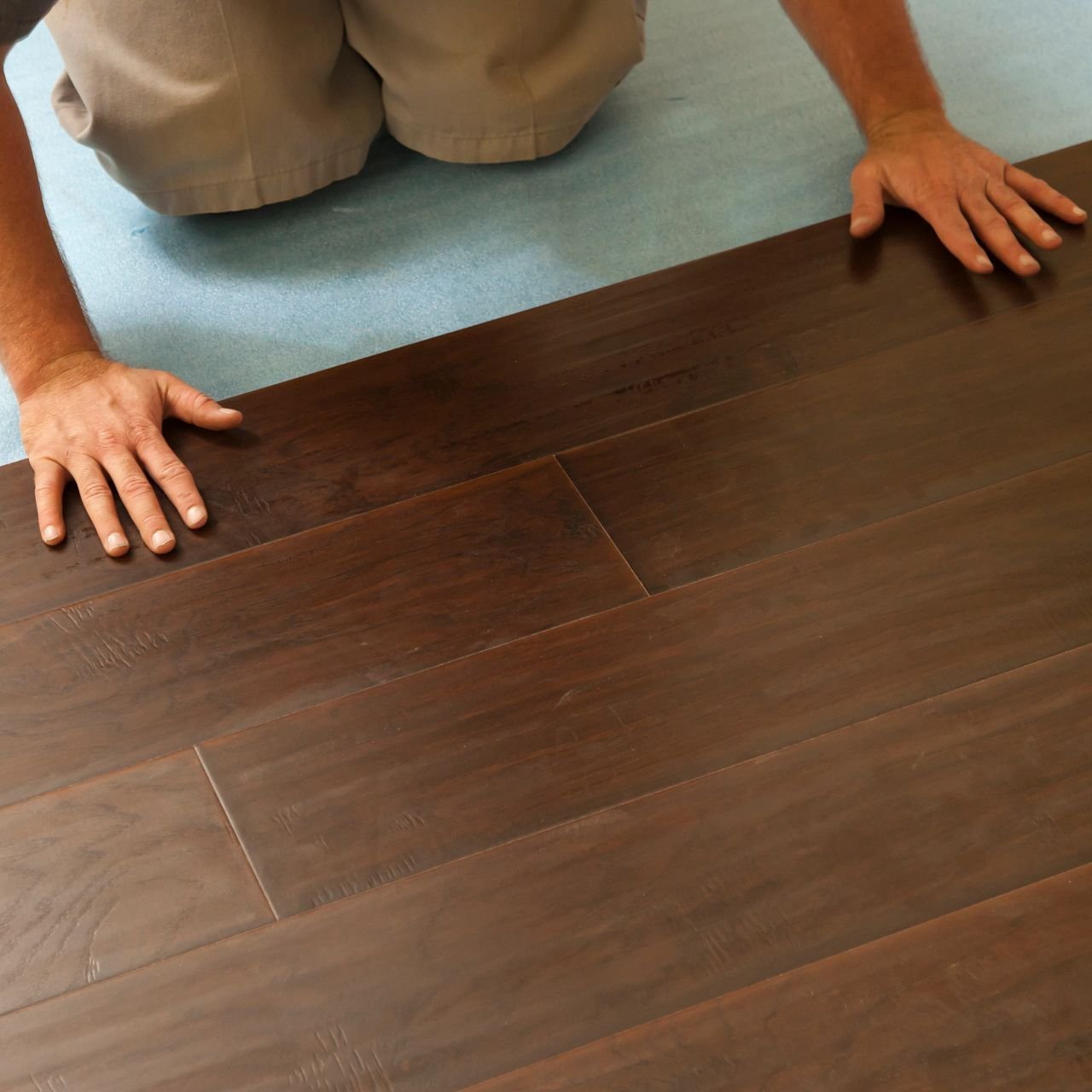 closeup of person installing flooring - Big Dog Flooring in Indianapolis, IN