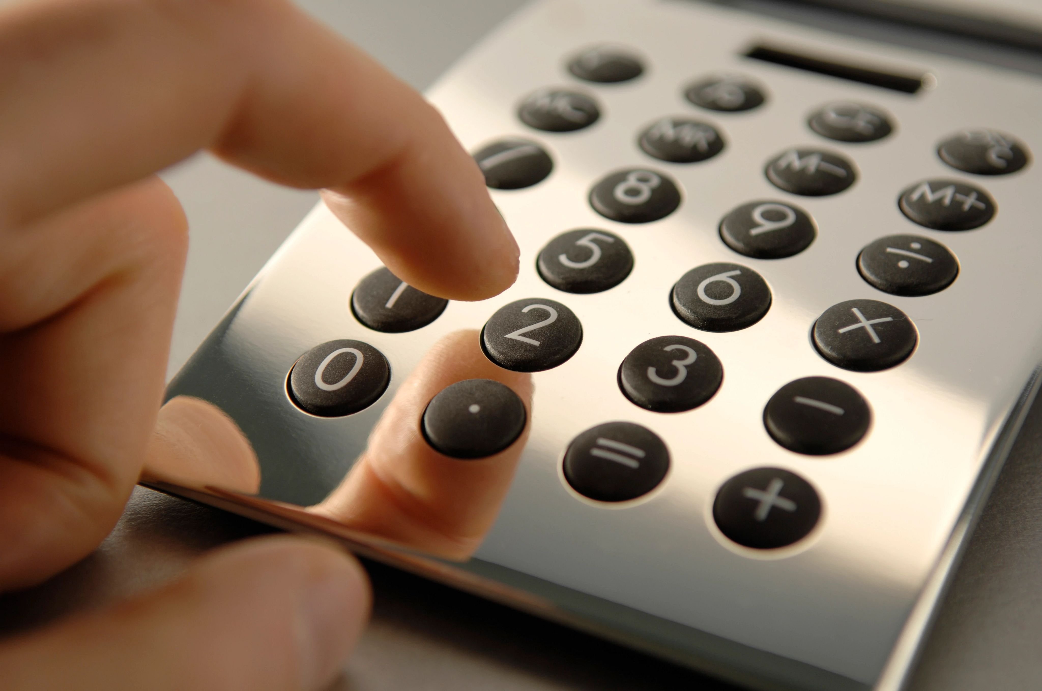 closeup of person using calculator - Big Dog Flooring in Indianapolis, IN